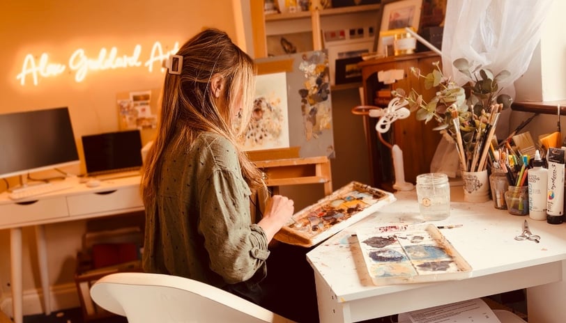 Alex Goddard working on a painting in her home studio