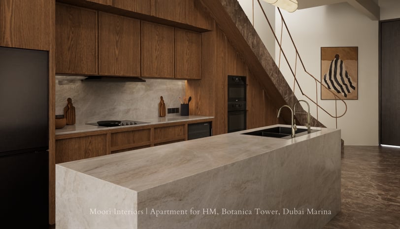 Warm wood kitchen with marble island under staircase, featuring integrated appliances and railing