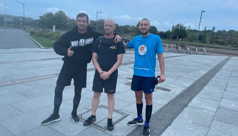 three runners posing for a photo