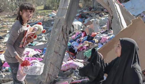A Girl Picking up Her Belongings after Her Home Was Destroyed in Gaza