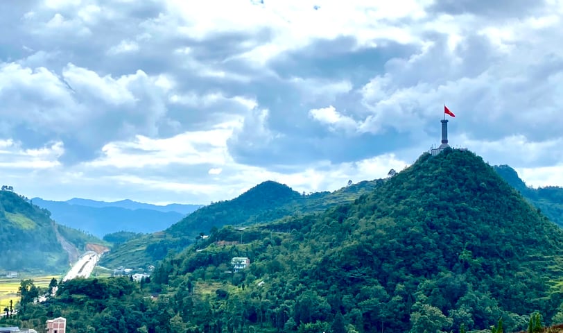 a flag flying over a mountain