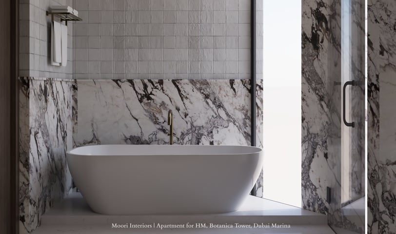 White tub in a bathroom with textured and Arabescato marble walls and a glass shower door.