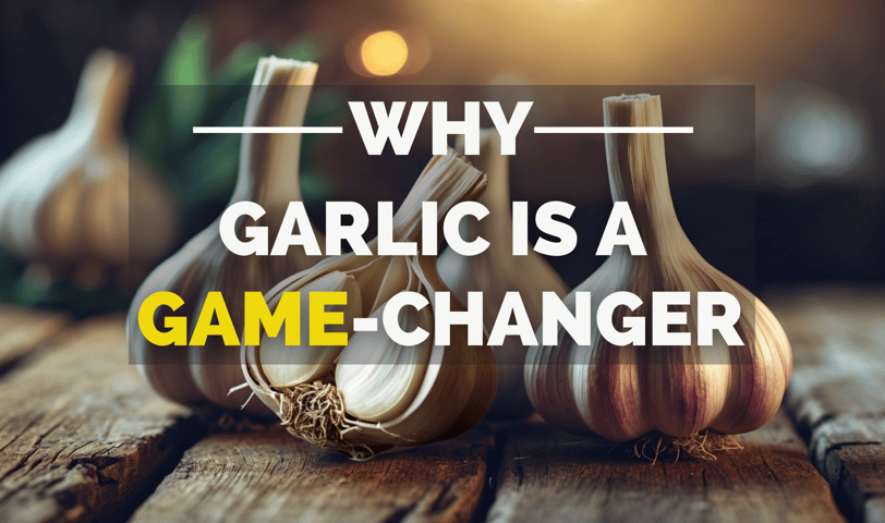 Three garlic bulbs on a wooden surface, one sliced to reveal the inside.
