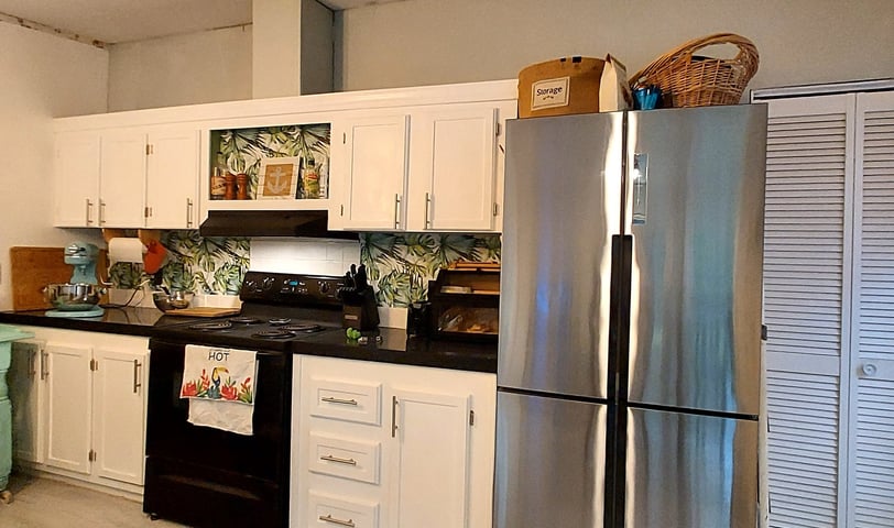 a kitchen with a refrigerator, refrigerator, and refrigerator freezer