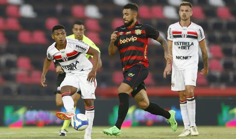 a soccer player is running with the ball