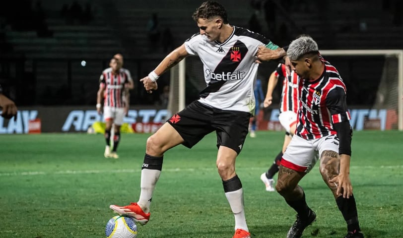 two men playing soccer on a field