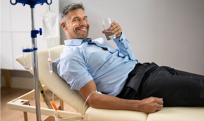 Specialized physician applying IV therapy with essential vitamins to strengthen the body, enhance th