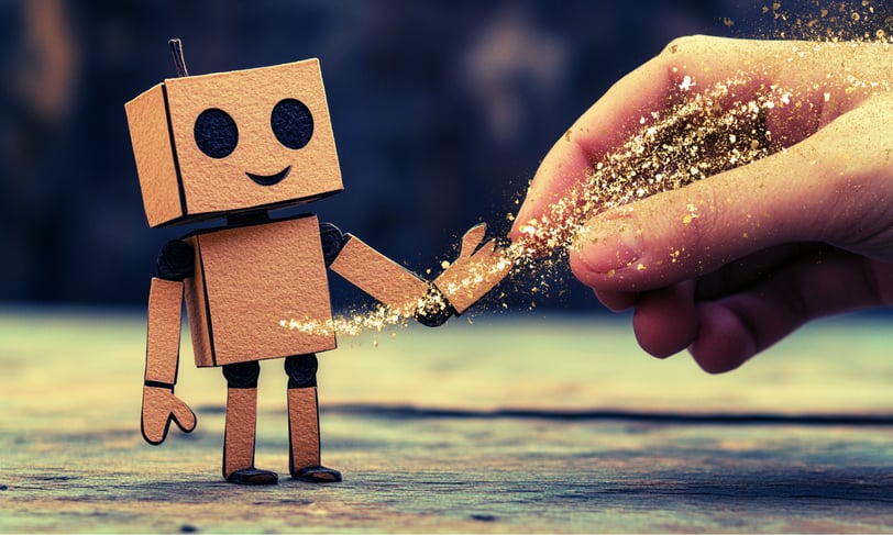 a person holding a small robot toy in front of a person's hand