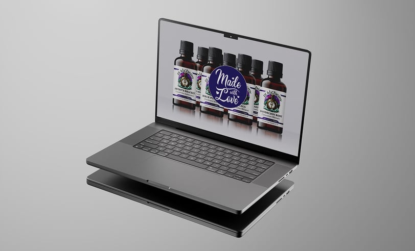 a laptop computer with PJ Alchemy website on