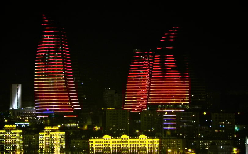 a city skyline with a lot of lights and buildings