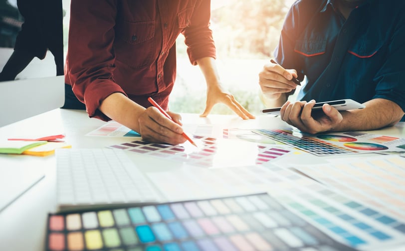 Graphic designers working on choosing colors for marketing materials