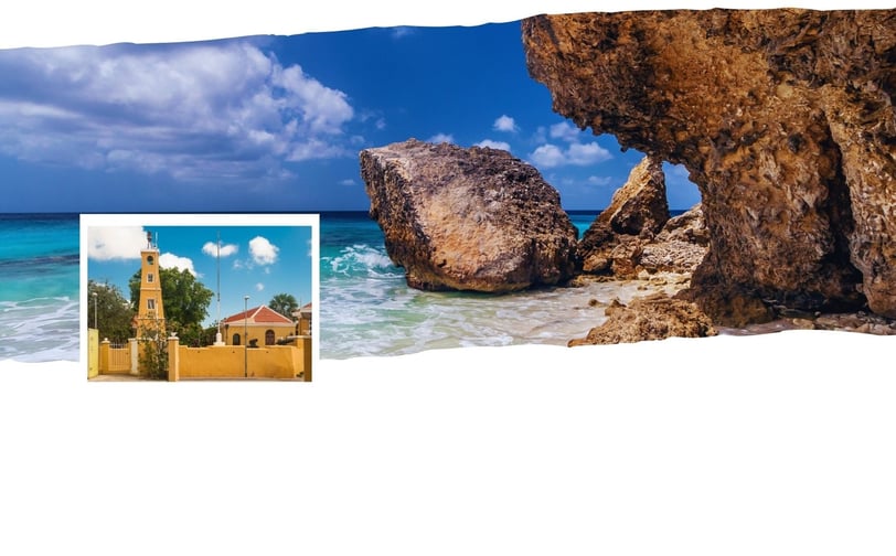 Vista de Kralendijk com praia ao fundo e o centro colorido em destaque.