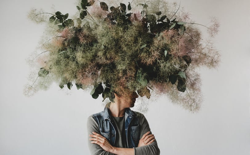 a man with a large head of flowers on his head