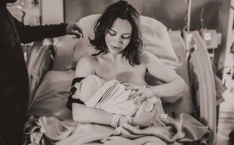 Mama holding her baby in the hospital bed right after birth