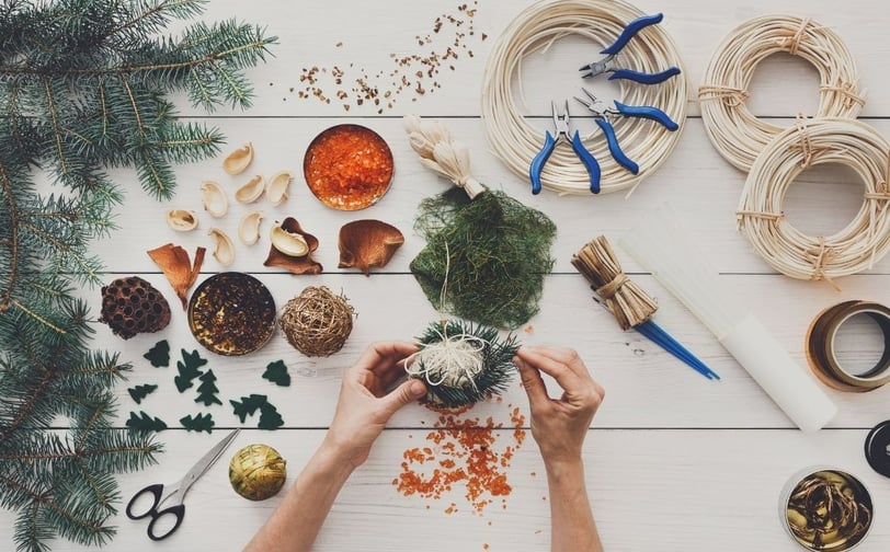 a person's hands are holding a christmas tree