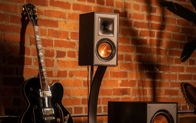 a guitar and a speaker system in a room