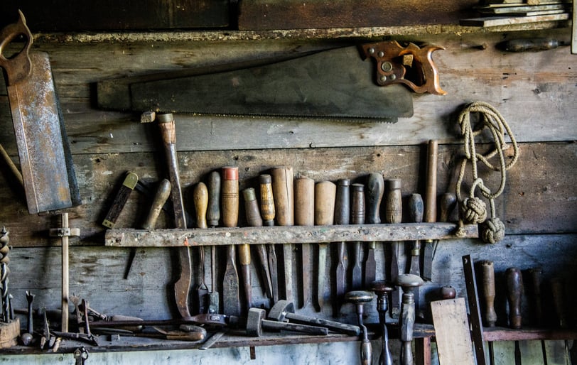 a bunch of woodworking tools on a wall