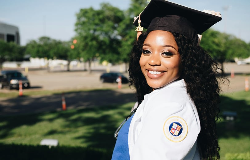 a woman in a graduation cap and gown