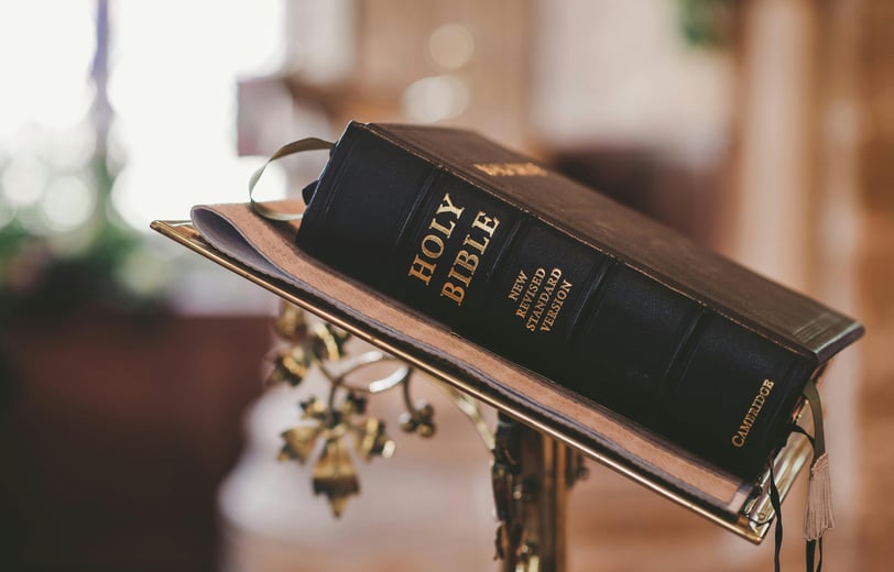 a bible with a bookmark on it and a cross on the side of a