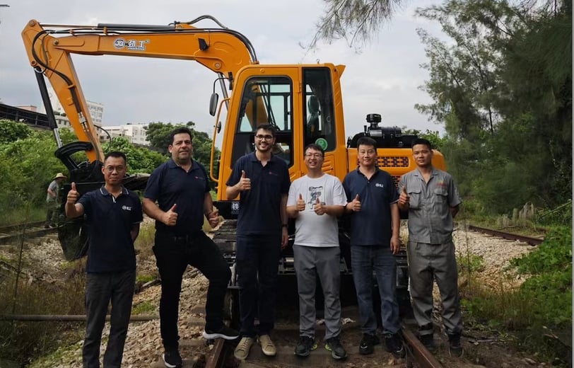a group of men standing on a train track