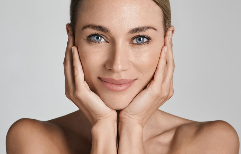 a woman with her hands cupped on her face