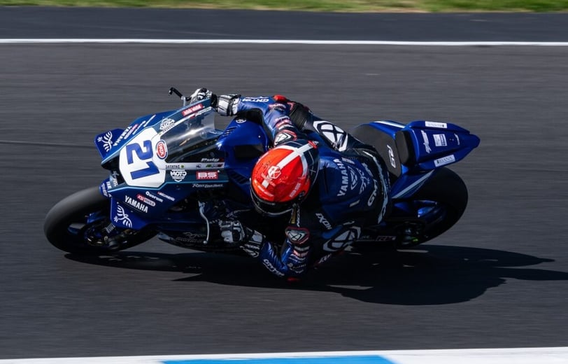 a person riding a motorcycle on a track