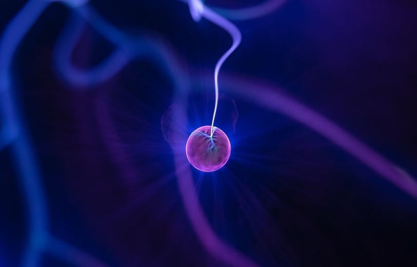Purple ball irradiating electricity in a blue background.