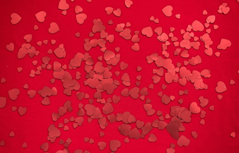 Numerous red hearts in a red background.