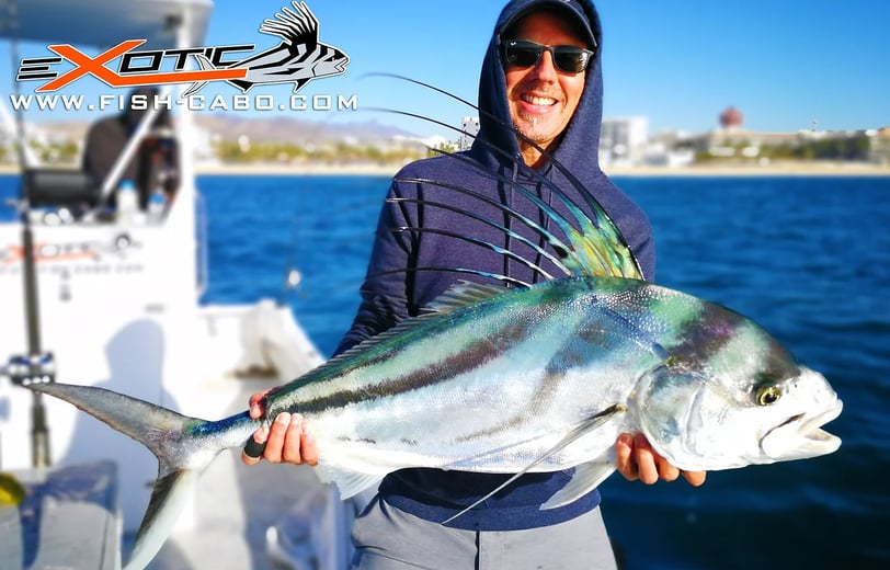 a man holding a fish fish on a boat