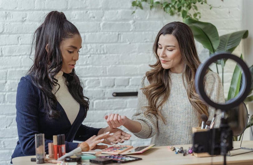 a woman in a white sweater and a woman in a blue sweater