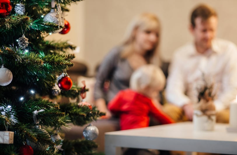 a family sitting on a couch in a living room