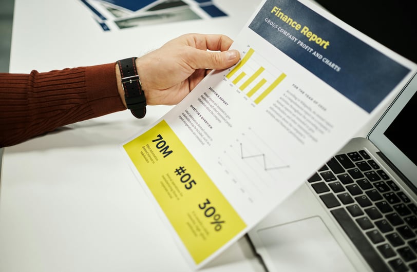a person holding a piece of paper with a business card