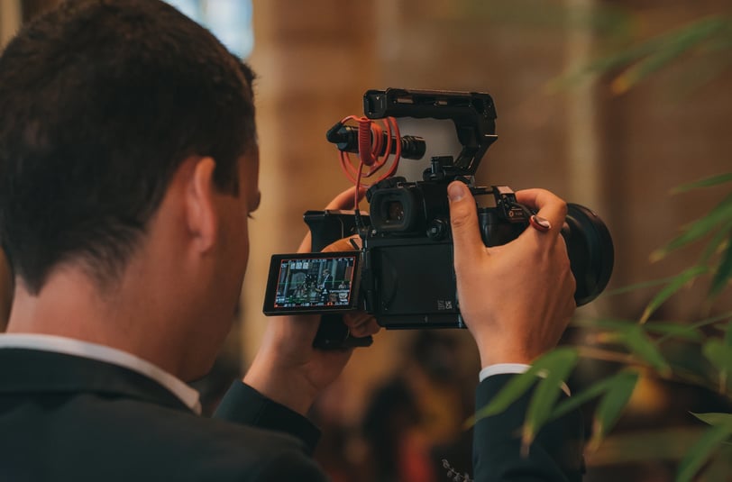 Vidéaste qui filme une scène de mariage avec sa caméra