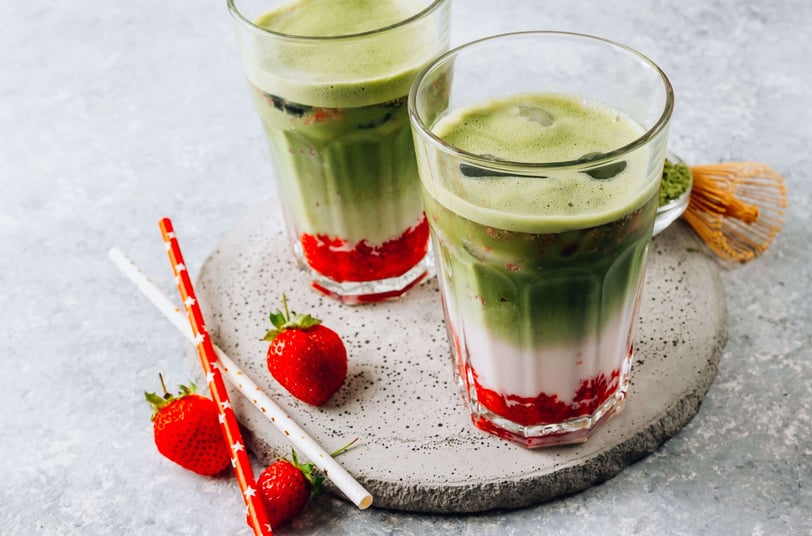 Layered strawberry matcha latte with fresh strawberries