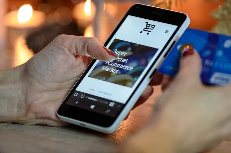 a person holding a credit card and a credit card