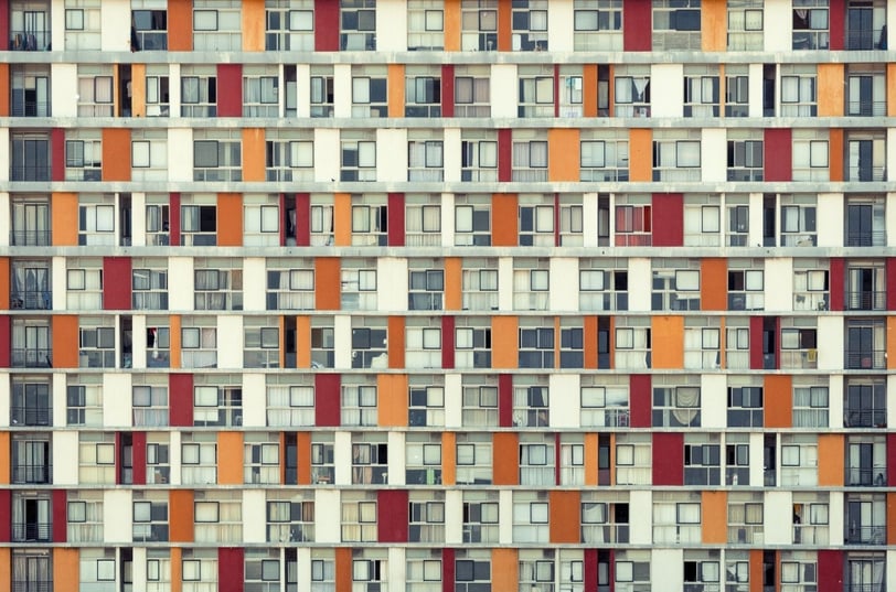 Fine art photograph by Martin Osner showing a colourful grid of apartment balconies and windows in an urban building facade