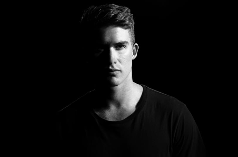 a man in a black shirt in a black and white photo