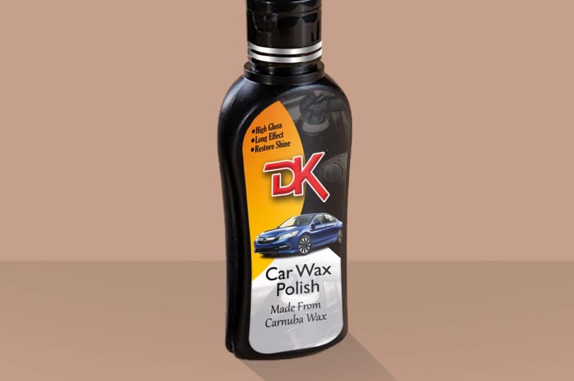 1. A bottle of carnauba wax polish on a brown background, enhancing car paint with high gloss and scratch removal properties.