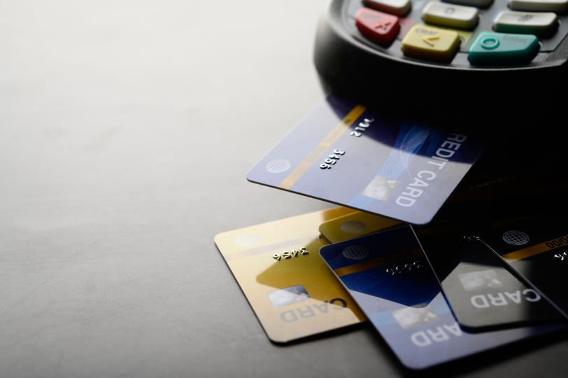 credit cards next to a payment reader