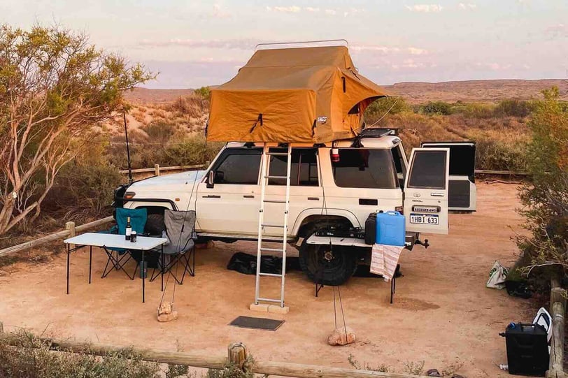 Landcruiser and camping setup at sunset in Western Australia.
