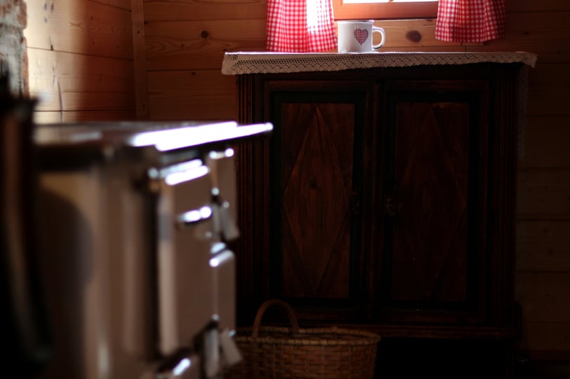 a kitchen with a stove and a basket on the counter