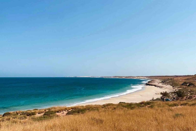 Wild Red Bluff Beach with its red cliffs and the Indian Ocean in the background, in Western Australia.