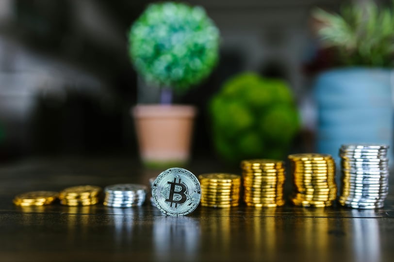 a stack of coins with a bitcoin bitcoin coin on top of