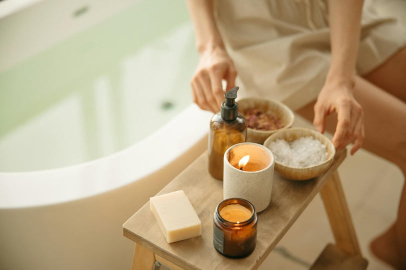 a woman in a bathtub with candles and spa products