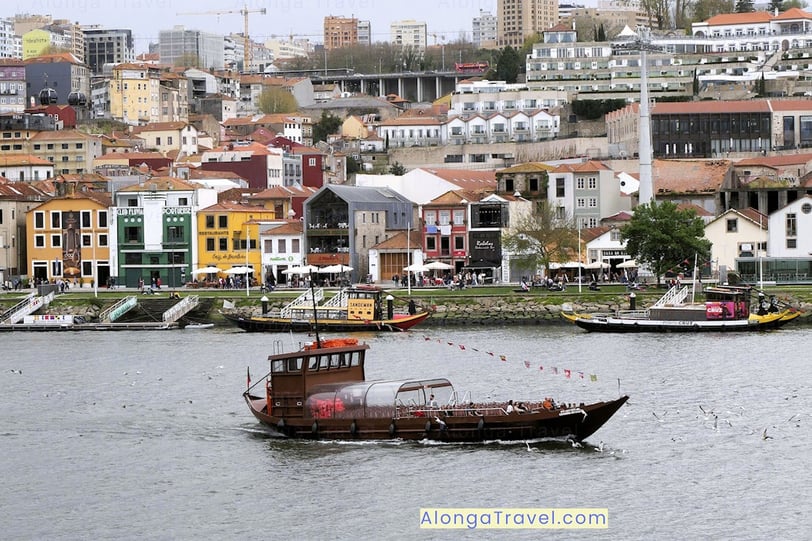 a brown boat on Douro River is taking passengers around Porto