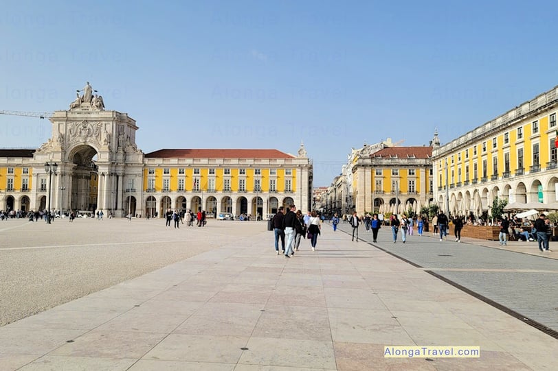 Wide square of commerce built during Pombaline reforms in Lisbon, with people enjoying their walk