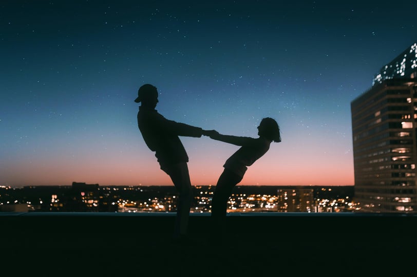 a man and woman dancing in the night