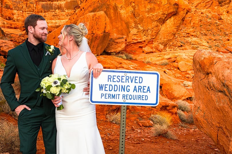 wedding couple by the valley of fire reserved wedding area sign
