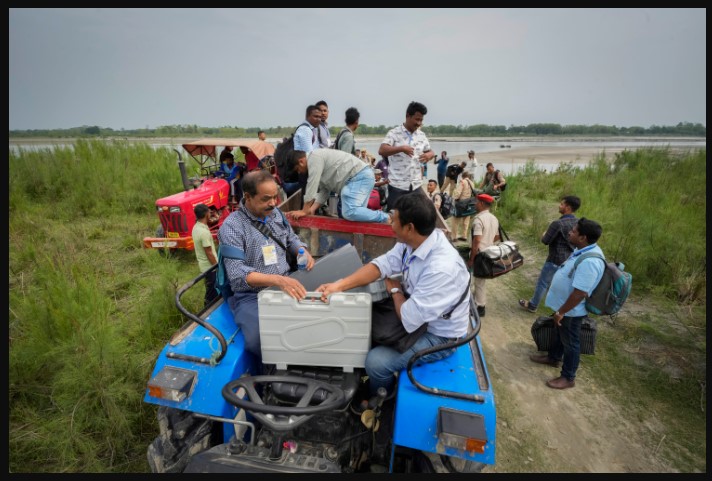 in india. voting machines escorted by security personnel on a tractor
