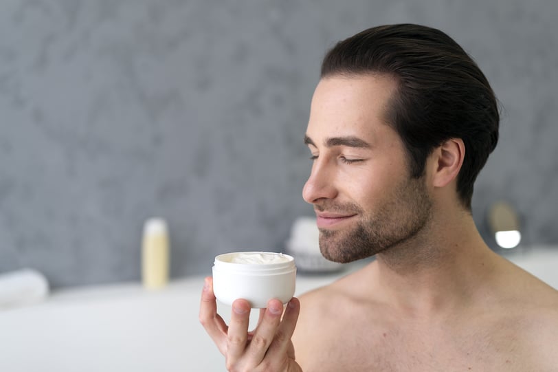 a man applying beard balm
